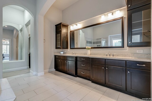 bathroom featuring tile patterned flooring, vanity, and an enclosed shower