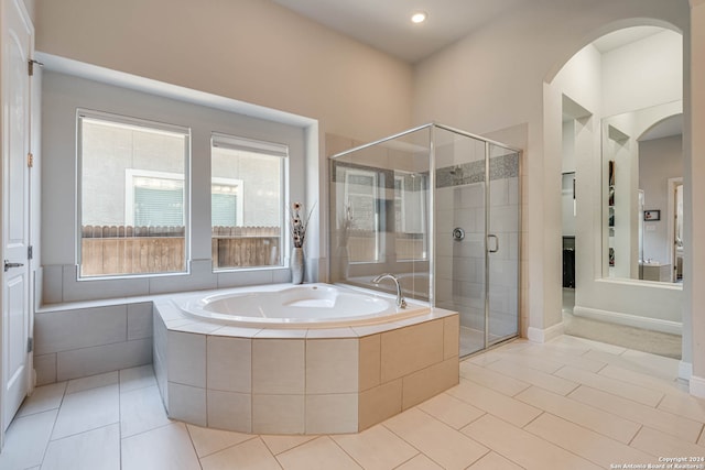 bathroom featuring tile patterned flooring and separate shower and tub