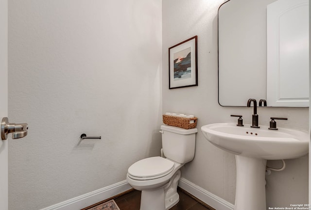 bathroom featuring tile patterned flooring and toilet