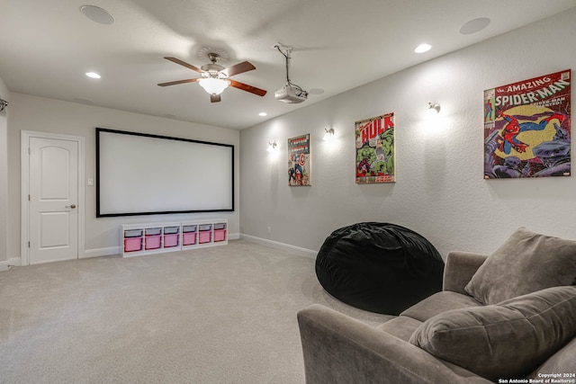 carpeted home theater with ceiling fan