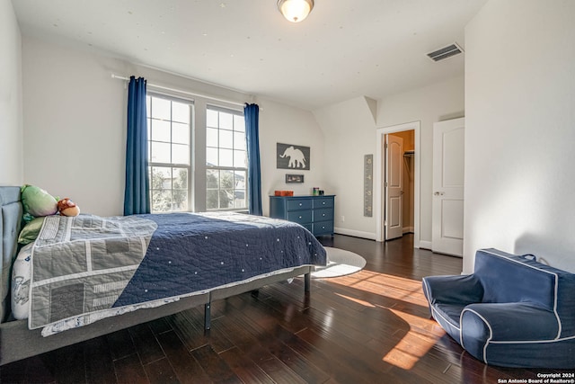 bedroom with dark hardwood / wood-style flooring