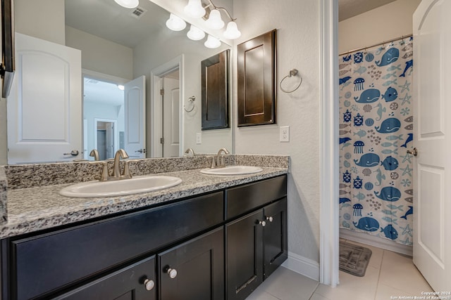 bathroom with tile patterned floors, vanity, and curtained shower