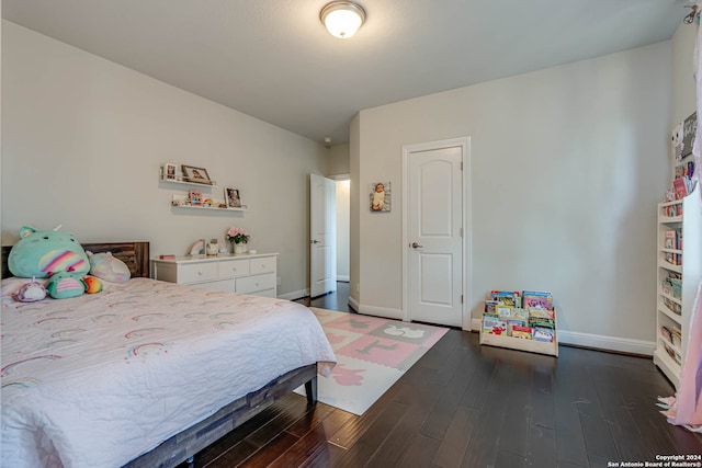 bedroom with dark wood-type flooring