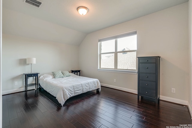 bedroom with dark hardwood / wood-style flooring and vaulted ceiling