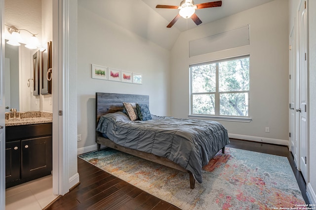 bedroom featuring ceiling fan, sink, dark wood-type flooring, and vaulted ceiling