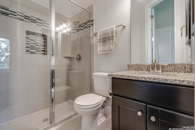 bathroom featuring vanity, toilet, and an enclosed shower