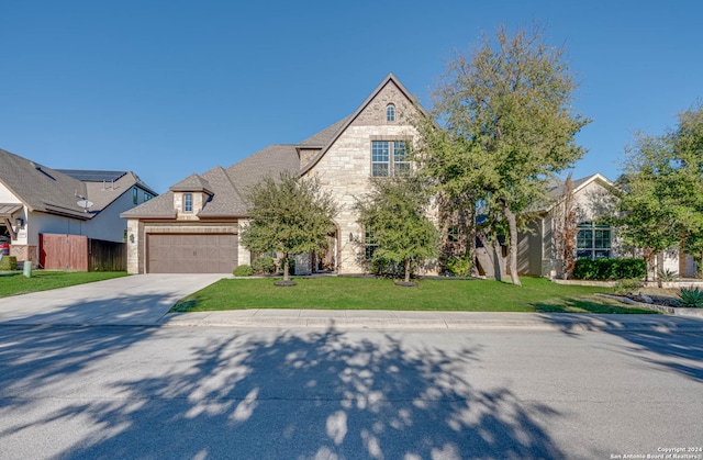 view of front of property with a front lawn and a garage