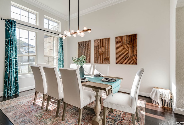 dining space with dark hardwood / wood-style flooring and crown molding