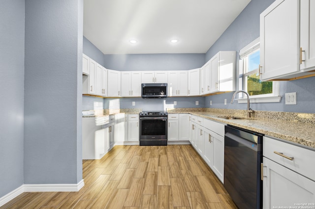 kitchen featuring white cabinets, sink, light stone countertops, and stainless steel appliances