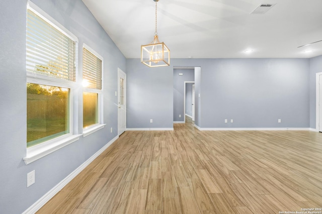 5882 Castle Run, San Antonio, TX 78218 - unfurnished room featuring light wood finished floors, a chandelier, and baseboards