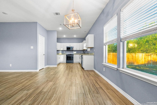 5882 Castle Run, San Antonio, TX 78218 - kitchen with appliances with stainless steel finishes, a chandelier, white cabinetry, and baseboards