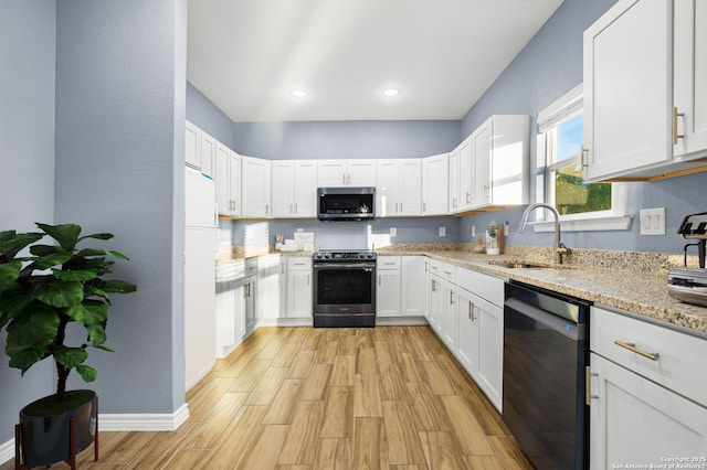 5882 Castle Run, San Antonio, TX 78218 - kitchen featuring appliances with stainless steel finishes, a sink, white cabinetry, light wood finished floors, and light stone countertops