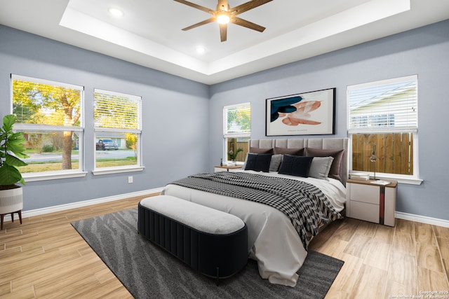 5882 Castle Run, San Antonio, TX 78218 - bedroom featuring a raised ceiling, baseboards, wood finished floors, recessed lighting, and ceiling fan