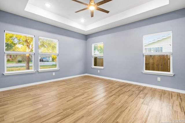 5882 Castle Run, San Antonio, TX 78218 - unfurnished room featuring a raised ceiling, light wood-style floors, a ceiling fan, baseboards, and recessed lighting