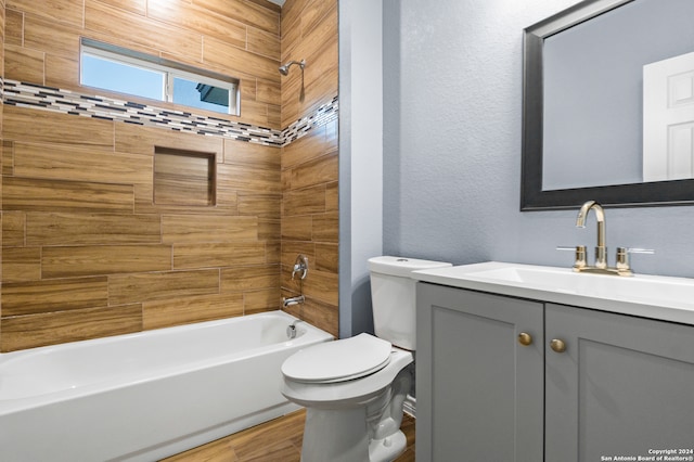 full bathroom with hardwood / wood-style flooring, toilet, vanity, and tiled shower / bath