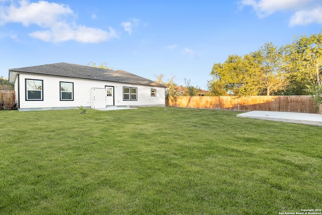 rear view of house with a patio area and a yard