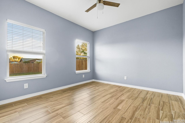5882 Castle Run, San Antonio, TX 78218 - unfurnished room with light wood finished floors, ceiling fan, and baseboards