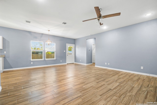 unfurnished living room with light hardwood / wood-style flooring and ceiling fan