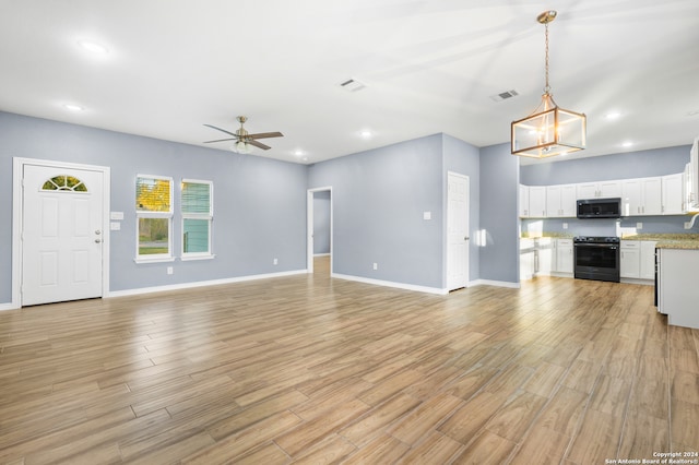 unfurnished living room featuring ceiling fan