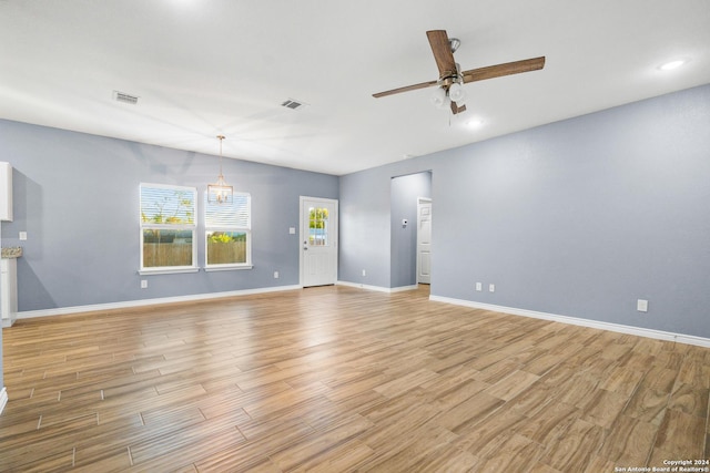 5882 Castle Run, San Antonio, TX 78218 - unfurnished room featuring ceiling fan, light wood finished floors, baseboards, recessed lighting, and a chandelier