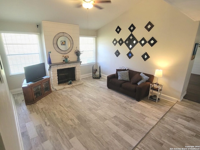 living room featuring a fireplace, wood-type flooring, ceiling fan, and lofted ceiling