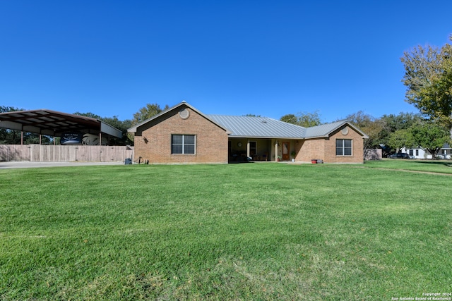 view of front of property featuring a carport and a front lawn