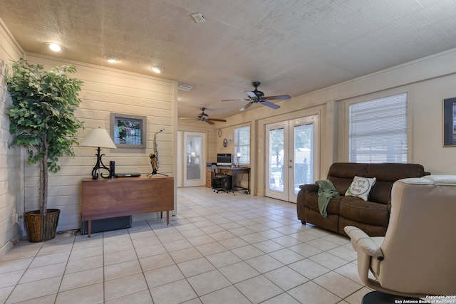 tiled living room featuring french doors, a textured ceiling, and ceiling fan