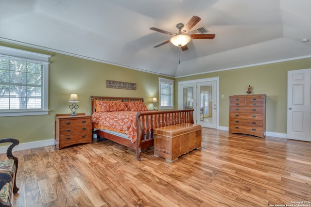 bedroom featuring vaulted ceiling, ceiling fan, light hardwood / wood-style flooring, and french doors