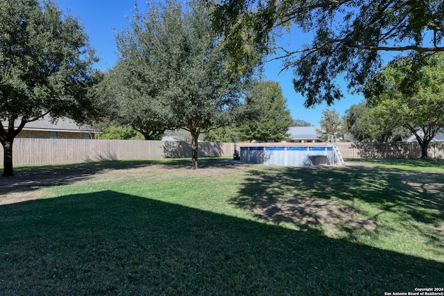 view of yard with a fenced backyard and a fenced in pool