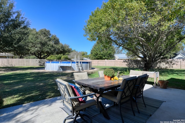 view of patio featuring a fenced in pool, outdoor dining area, and a fenced backyard