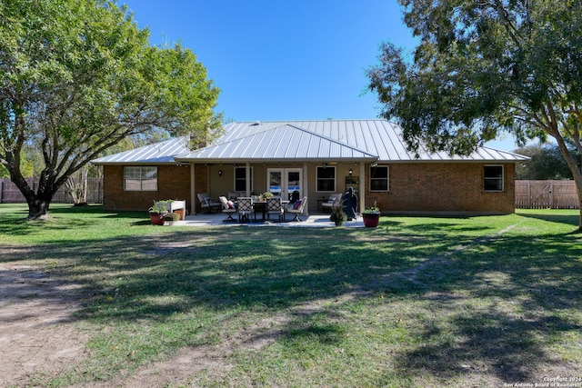 back of house featuring a patio area, a yard, and french doors