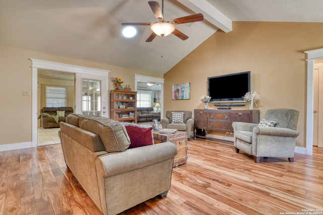 living room with vaulted ceiling with beams, light wood-style floors, ceiling fan, and baseboards