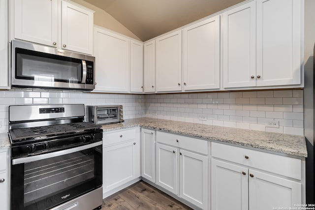 kitchen with white cabinetry, stainless steel appliances, backsplash, wood-type flooring, and lofted ceiling