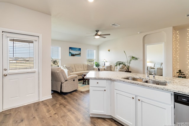 kitchen featuring light wood-type flooring, sink, dishwasher, white cabinetry, and lofted ceiling