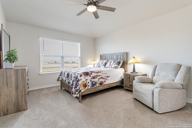 bedroom with carpet floors, ceiling fan, and lofted ceiling