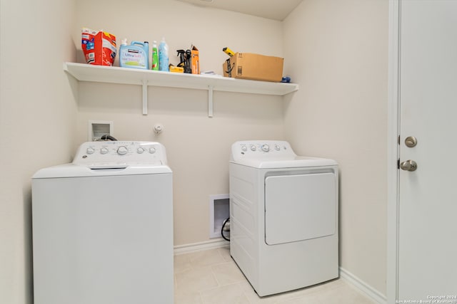 laundry area with light tile patterned floors and separate washer and dryer