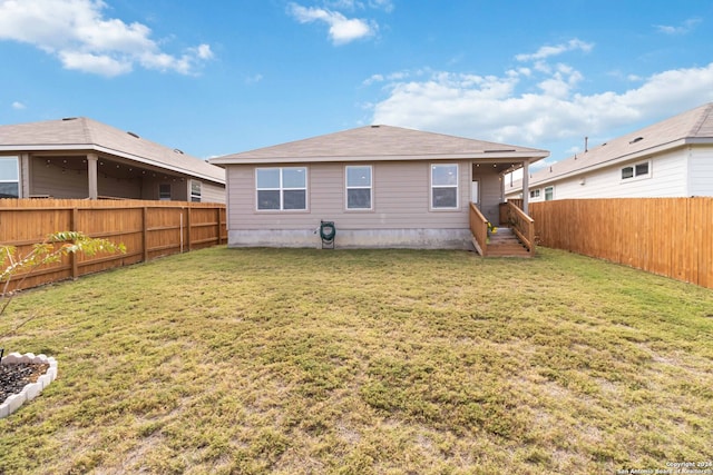 rear view of house with a lawn