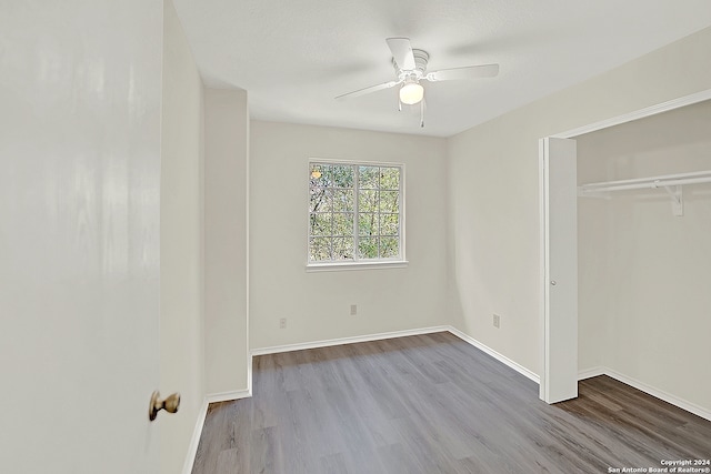 unfurnished bedroom featuring ceiling fan, a closet, and light hardwood / wood-style flooring