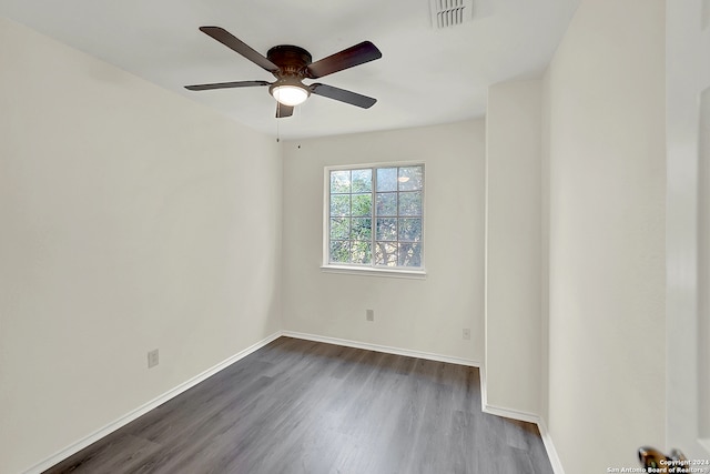 spare room with ceiling fan and dark hardwood / wood-style flooring