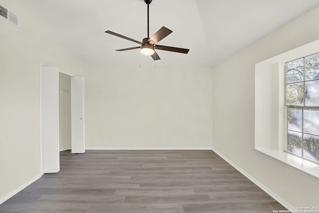 spare room featuring ceiling fan, hardwood / wood-style floors, and vaulted ceiling