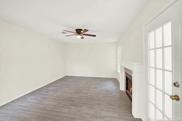 unfurnished living room with ceiling fan and hardwood / wood-style floors