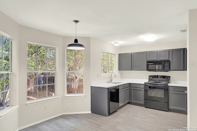 kitchen featuring sink, gray cabinets, a wealth of natural light, and black appliances