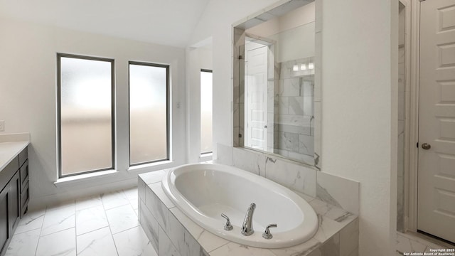 full bath featuring marble finish floor, vanity, and a bath