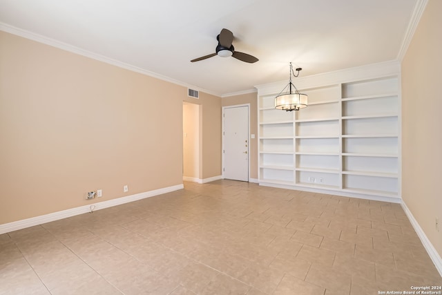 empty room with ornamental molding, ceiling fan with notable chandelier, and built in shelves