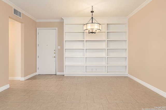 unfurnished dining area with crown molding, a chandelier, and built in features