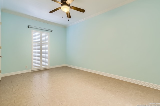 tiled spare room featuring ceiling fan and ornamental molding