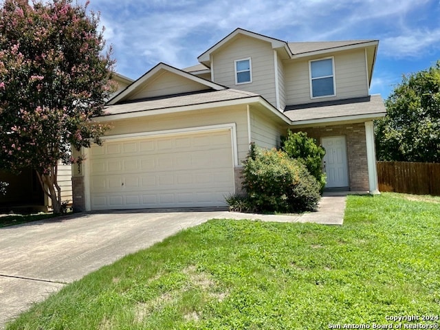 view of front of home featuring a garage and a front lawn