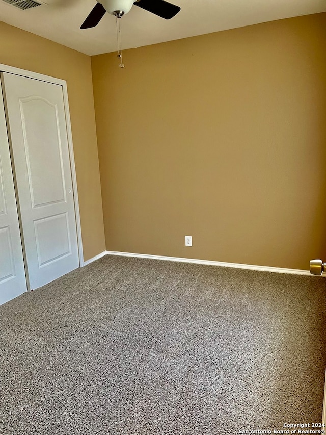 carpeted empty room with ceiling fan