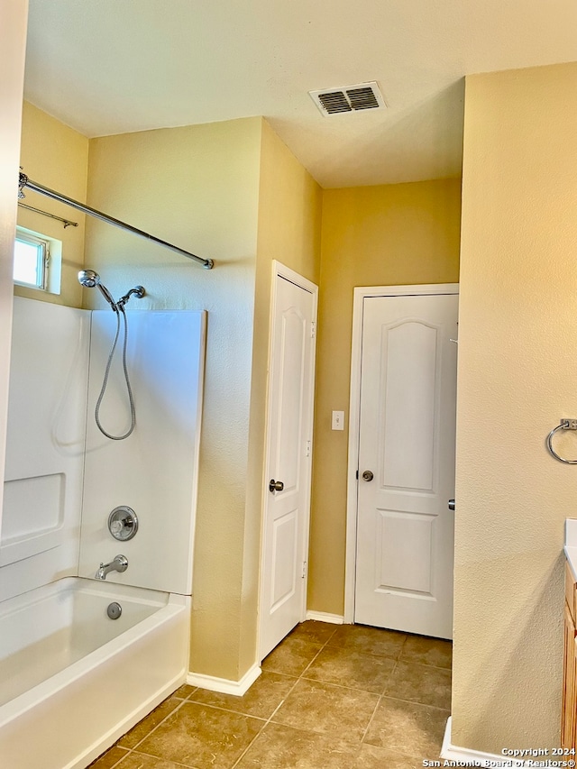 bathroom with tile patterned flooring, vanity, and shower / washtub combination