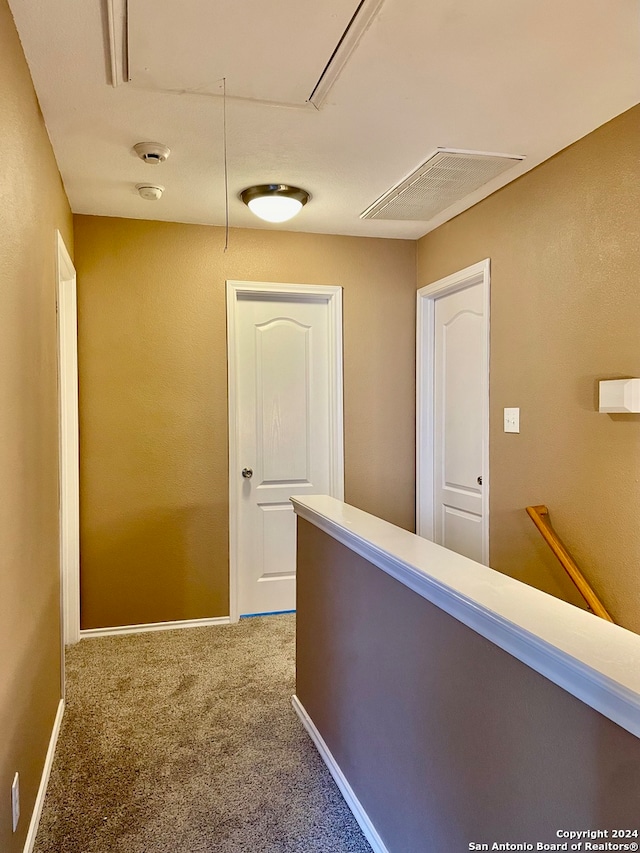 hallway featuring carpet flooring